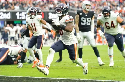  ?? AP ?? Damien Williams scoots into the end zone on a four-yard run in the second quarter to give the Bears a 14-3 lead. The Bears rushed for 143 yards on 37 carries.