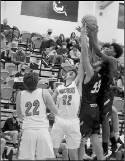  ?? Photo by Gerren Smith ?? A WAR FOR POSSESSION: The Magnet Cove Panthers and the Poyen Indians battle for possession under the basket to secure a rebound during an intense rivalry hoops showdown in their 5-2A Conference opener.