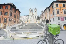  ??  ?? A delivery man surveys the Spanish Steps at the deserted Piazza di Spagna on Thursday in central Rome.