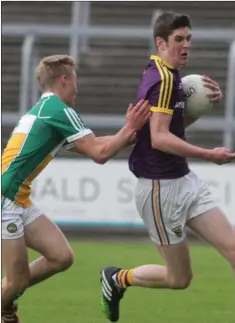  ??  ?? Seán Forde of Wexford is challenged by Offaly’s Ciarán Farrell in Friday’s Leinster Under-17 football championsh­ip clash.