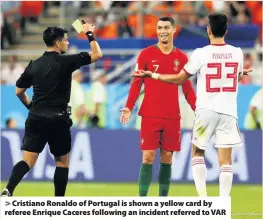  ??  ?? > Cristiano Ronaldo of Portugal is shown a yellow card by referee Enrique Caceres following an incident referred to VAR