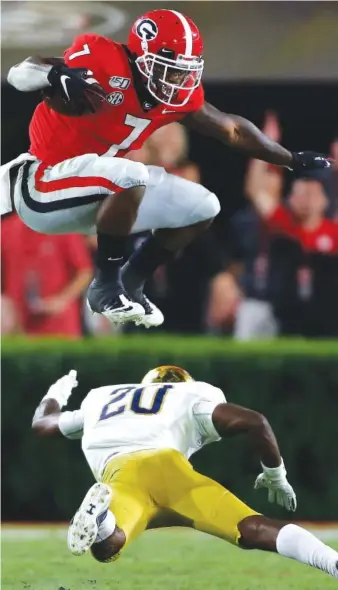  ?? PHOTO BY CURTIS COMPTON/ATLANTA JOURNAL CONSTITUTI­ON VIA AP ?? Georgia running back D’Andre Swift leaps over Notre Dame cornerback Shaun Crawford during the second half of Saturday night’s game in Athens, Ga. Georgia won 23-17.