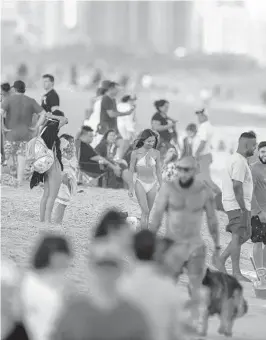  ?? MICHAEL LAUGHLIN/SUN SENTINEL ?? Thousands of people flock to Fort Lauderdale’s beach Saturday to celebrate New Year’s Day. A proposed bill coming before the state Legislatur­e this year would let cities ban smoking at the beach.