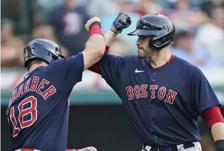  ?? AP PHotos ?? GOING DEEP: J.D. Martinez, right, celebrates with Kyle Schwarber after hitting a three-run home run in the 10th inning against the Indians on Saturday in Cleveland. Below, Schwarber rounds the bases after hitting a solo homer in the first.