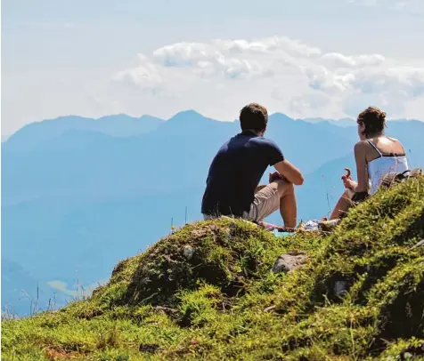  ?? Foto: Andreas Gebert, dpa ?? Ein wahres Hochgefühl: Bei schönem Wetter oben auf dem Gipfel sitzen und Brotzeit machen – für Bergfans gibt es kaum etwas Schöneres. Und die Zahl derer, die hoch hinaus wollen, wird immer größer.