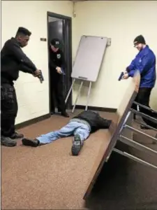  ?? GINGER RAE DUNBAR — DIGITAL FIRST MEDIA ?? Delaware County Technical High School students detain a suspect in an active shooter drill held Friday at the training center.