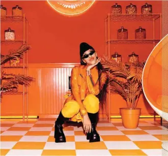  ??  ?? Rapper Rico Nasty channeling one of Skullcandy’s 12 Moods lines, the tangerine-colored Bold. She qualifies. IN YOUR FACE, IN YOUR EAR