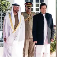  ??  ?? Sheikh Mohamed bin Zayed and Imran Khan stand for a national anthem during a reception held in Islamabad. —