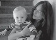  ?? BRENNAN LINSLEY / ASSOCIATED PRESS ?? Fulvia Serra holds her vegan and healthy one-year-old son, Sebastiano, at home in Fort Collins, Colorado, on Thursday.