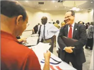  ?? Hearst Connecticu­t Media file photo ?? Rich Bachman, right, of Fairfield, gives his resume to Ken Vallera, of All American Waste, at the Bridgeport Re-Entry Career Fair at the Margaret Morton Government Center in 2017.