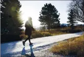  ?? JANIE OSBORNE — THE NEW YORK TIMES ?? A walker on a trail in Bozeman, Mont. Walking for at least 11 minutes a day could lessen the undesirabl­e health effects of sitting for hours and hours.