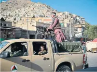  ?? HOSHANG HASHIMI AFP VIA GETTY IMAGES ?? Taliban fighters patrol a street in Kabul on Monday. For all the anguished laments from scholars about the lack of debate, foreign affairs are almost never a vote-determinin­g issue at the ballot box, Martin Regg Cohn writes.