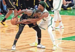  ?? PAUL RUTHERFORD/USA TODAY SPORTS ?? Warriors forward Draymond Green handles the ball against Celtics defender Marcus Smart during the first half of Game 4.