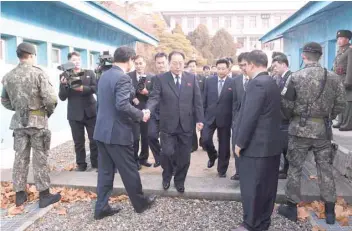  ?? — AFP ?? Head of North Korean delegation Jon Jong Su, Vice Chairman of Committee for the Peaceful Reunificat­ion of the Country of DPRK, crosses the concrete border to attend their meeting at the truce village of Panmunjom on Wednesday.