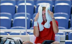  ?? Patrick Semansky / Associated Press ?? Daniil Medvedev of the Russian Olympic Committee cools off during a changeover in his win against Alexander Bublik of Kazakhstan.