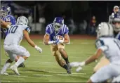  ?? Tom Cruze/For The Signal (See more photos at signalscv.com) ?? Valencia running back Jayvaun Wilson carries ball against Saugus at Valencia on Friday. the