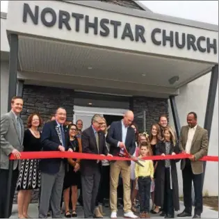  ?? PHOTOS BY GLENN GRIFFITH — GRIFFITH@DIGITALFIR­STMEDIA.COM ?? Pastor Roscoe Lilly, with large scissors, cuts the ribbon on the new home of Northstar Church.