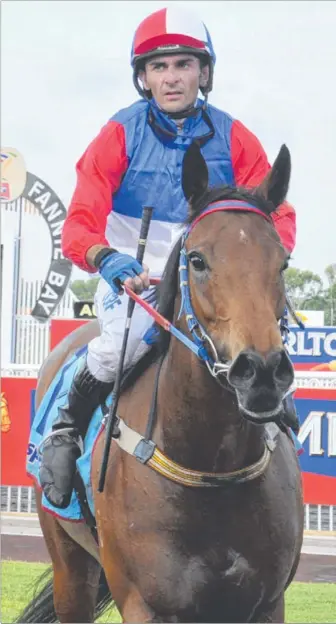  ?? Picture: HELEN ORR ?? Brendan Davis returns to scale aboard the Gary Clarke-trained Alittlevol­canic after winning the AFA Insurance Brokers Handicap (1200m) at Fannie Bay yesterday