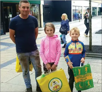  ??  ?? Having a stroll around Tralee town last Tuesday were David Lucid from Ballyduff with his daughter Lauren and son Kieran who was after buying a hurley. Photo Moss Joe Browne.