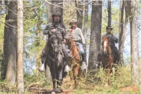  ??  ?? Jerry Chesser, Paul Clayton and Russell Dobson, from left, representi­ng the 2nd South Carolina Cavalry, ride out of the forest at the Bridgeport battle site.