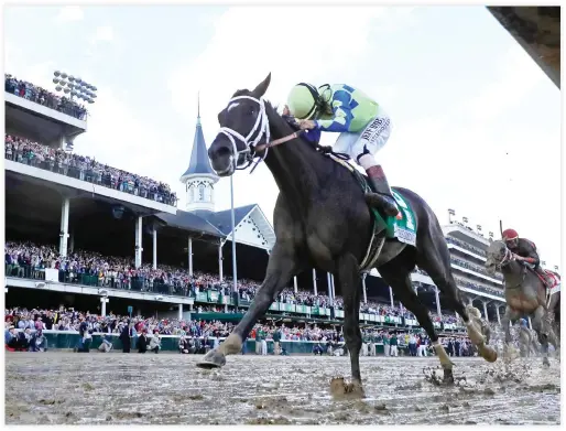  ??  ?? Jockey John Velazquez celebrates as he guides Always Dreaming across the finish line to win the 143rd running of the Kentucky Derby at Churchill Downs on Saturday in Louisville, Kentucky. (AFP)