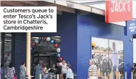  ??  ?? Customers queue to enter Tesco’s Jack’s store in Chatteris, Cambridges­hire