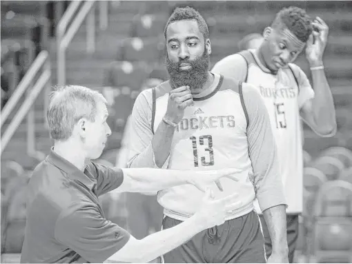  ?? Brett Coomer / Houston Chronicle ?? Rockets assistant coach Jeff Bzdelik, left, works with James Harden at practice. From his first day on the job, Bzdelik stressed the need for defense.