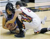  ?? LUIS SÁNCHEZ SATURNO/THE NEW MEXICAN ?? Socorro’s Zoe Esquivel, left, and Santa Fe Indian School’s Cameron Conners battle for a loose ball Friday in the first round of the Class 4A State Tournament.