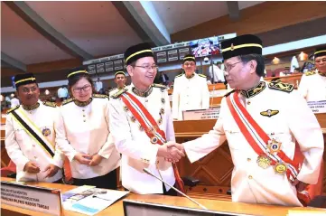  ??  ?? Shafie (right) shakes hands with his deputy Datuk Seri Wilfred Madius Tangau while his two other deputies, Christina Lew (second left) and Datuk Dr Jaujan Sambakung (left) look on. — Bernama photo