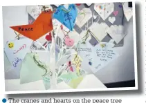  ??  ?? ●●The cranes and hearts on the peace tree