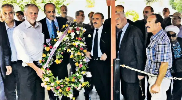  ??  ?? Jeremy Corbyn pictured in 2014 holding a wreath at a cemetery in Tunis