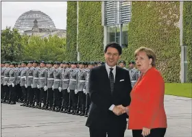  ?? AP/MARKUS SCHREIBER ?? German Chancellor Angela Merkel welcomes the Prime Minister of Italy Giuseppe Conte for talks at the chanceller­y in Berlin, on Monday.