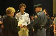  ?? PHOTO COURTESY OF UPPER GWYNEDD POLICE DEPARTMENT ?? Upper Gwynedd police Sgt. Ray Royds, center, receives his new rank from District Judge Suzan Leonard during a police promotion ceremony on July 22.