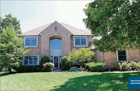  ?? CONTRIBUTE­D PHOTOS BY KATHY TYLER ?? The brick facade incorporat­es a tall arched covered entrance with a keystone accent at the top. Landscaped flower beds along the walkway are filled with evergreens, hostas, roses and other blooming bushes.