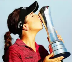  ??  ?? Hall celebrates winning the Women’s British Open with the trophy. — Reuters photo