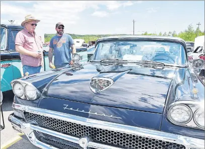  ?? KEVIN ADSHADE/THE NEWS ?? Ron Wilson and his son Shane admire Ron’s 1958 Ford Fairlane.