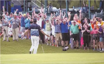  ?? AP PHOTO ?? CROWD PLEASER: Kevin Kisner hears it from the fans after chipping in for eagle at 18 to force a playoff yesterday at the Zurich Classic in Avondale, La.