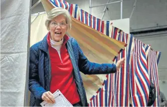  ?? NANCY LANE/BOSTON HERALD ?? WIN: Sen. Warren exits the ballot box in Cambridge yesterday.