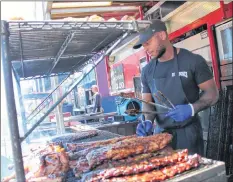  ?? CARLA ALLEN ?? Eric Masters grills the ribs at Billy Bones BBQ.