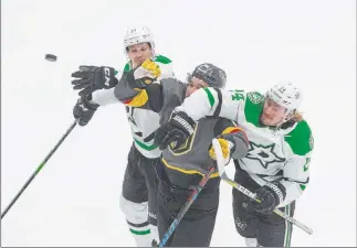  ?? Jason Franson The Associated Press ?? Denis Gurianov, left, and Roope Hintz of the Dallas Stars put the squeeze on Golden Knights wing Mark Stone, center, in a race for a loose puck in the first period of Game 2.