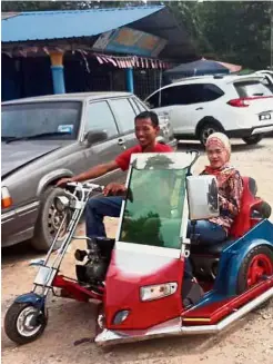  ??  ?? Wonderful toys: Azamrudin taking his racing car replica for a ride, and (top) he is seen ferrying a passenger in his motorcycle sidecar at Felda Sening in Kota Tinggi.