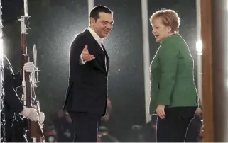  ??  ?? Prime Minster Alexis Tsipras welcomes German Chancellor Angela Merkel to the Maximos Mansion in Athens yesterday for talks on economic reforms, migration and regional issues including the name deal, for which she expressed support.