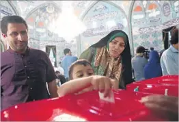  ?? BEHROUZ MEHRI/GETTY-AFP ?? An Iranian boy casts his mother’s ballot for president Friday in Tehran, the capital.