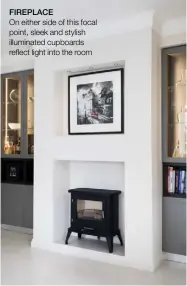  ??  ?? FIREPLACE
On either side of this focal point, sleek and stylish illuminate­d cupboards reflect light into the room