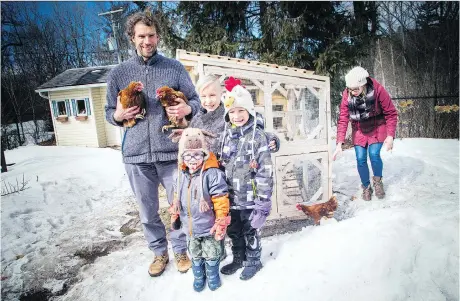  ?? PHOTOS: ASHLEY FRASER ?? Carmen and Matthew Chase show off their three chickens their family has in the backyard of their Gatineau home. Two-year-old Errol, five-year-old Ewan and seven-year-old Edmund pose with their dad as Carmen gets the third chicken who wasn’t quite ready...