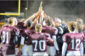  ?? MJ MCCONNEY - FOR DIGITAL FIRST MEDIA ?? Head coach Bill Hawthorne, facing, and the Pottsgrove football team raise the trophy after winning the District 1-4A championsh­ip Friday.