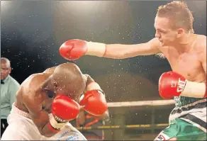  ?? Picture: FILE ?? GETTING A LOWDOWN: Dalisizwe Komani ducks a punch from Hekkie Budler. Budler won by KO