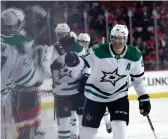  ??  ?? Stars center Jason Spezza (90) celebrates with teammates after scoring against the Flames at Scotiabank Saddledome. BRUCE FEDYCK/USA TODAY SPORTS