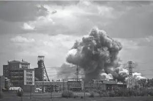  ?? ARIS MESSINIS/AFP VIA GETTY IMAGES ?? Smoke and dirt ascend after a strike at a factory in the city of Soledar at the eastern Ukrainian region of Donbas on Tuesday, the 90th day of the Russian invasion of Ukraine.