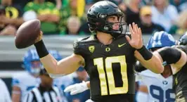  ?? ANDY NELSON/AP ?? Oregon quarterbac­k Bo Nix looks to throw against BYU during the first half Saturday in Eugene, Ore.